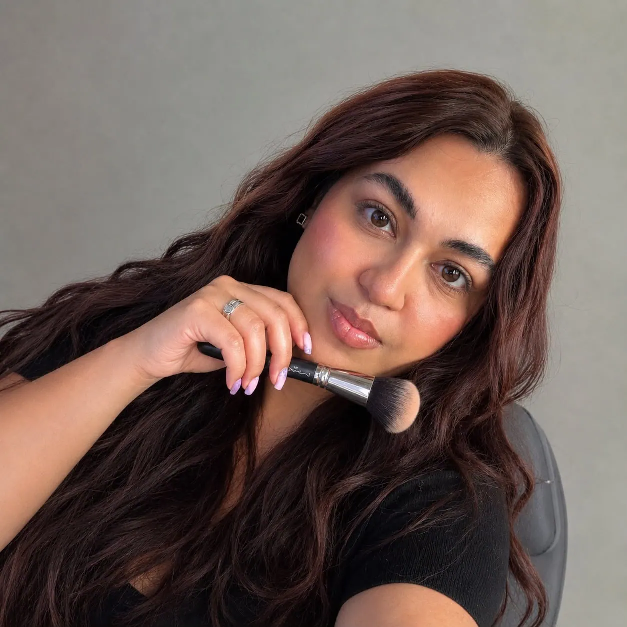 Bedoya working on a client during a makeup appointment