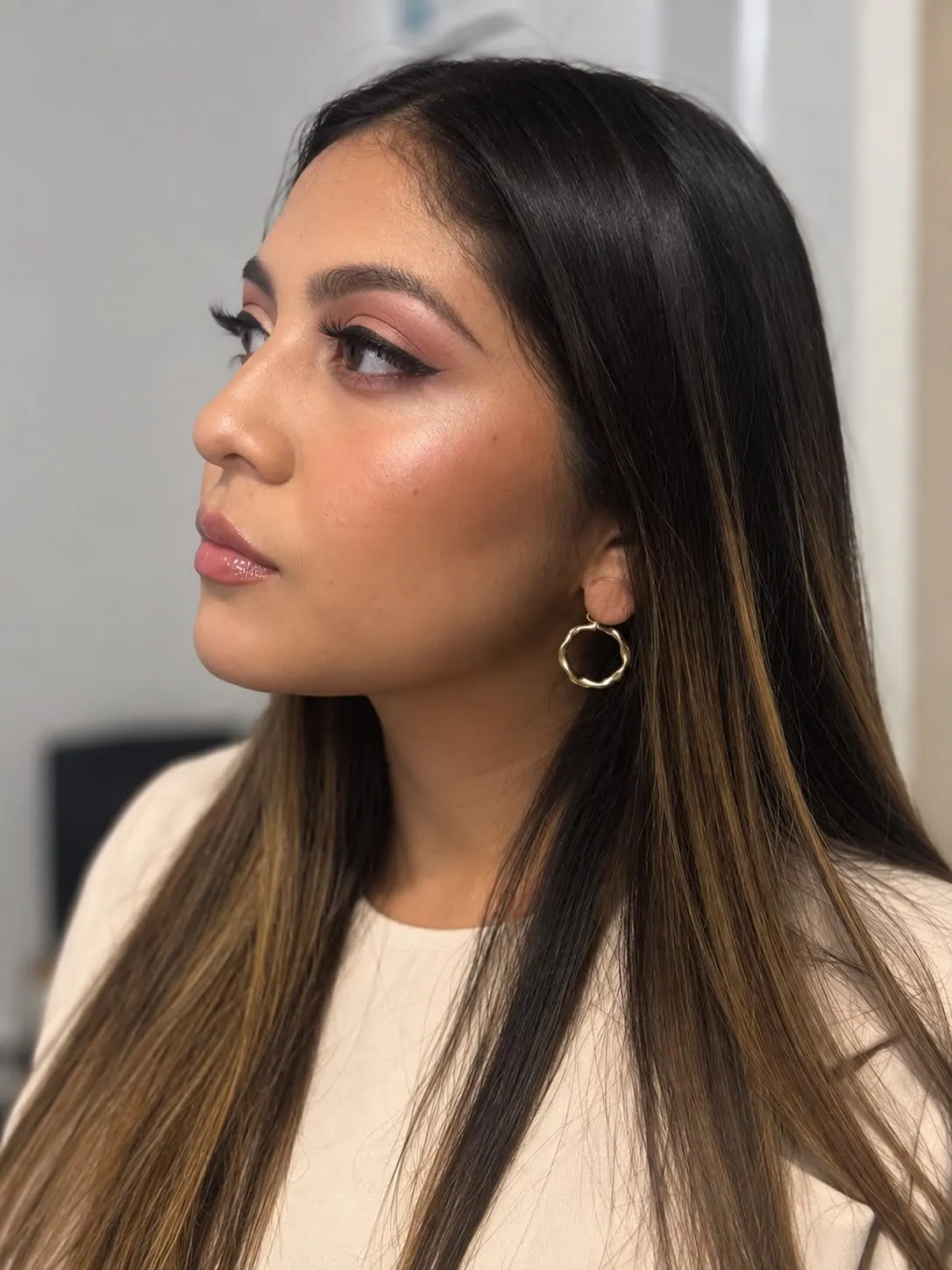 Soft glam portrait with luminous skin and warm bronze eyes